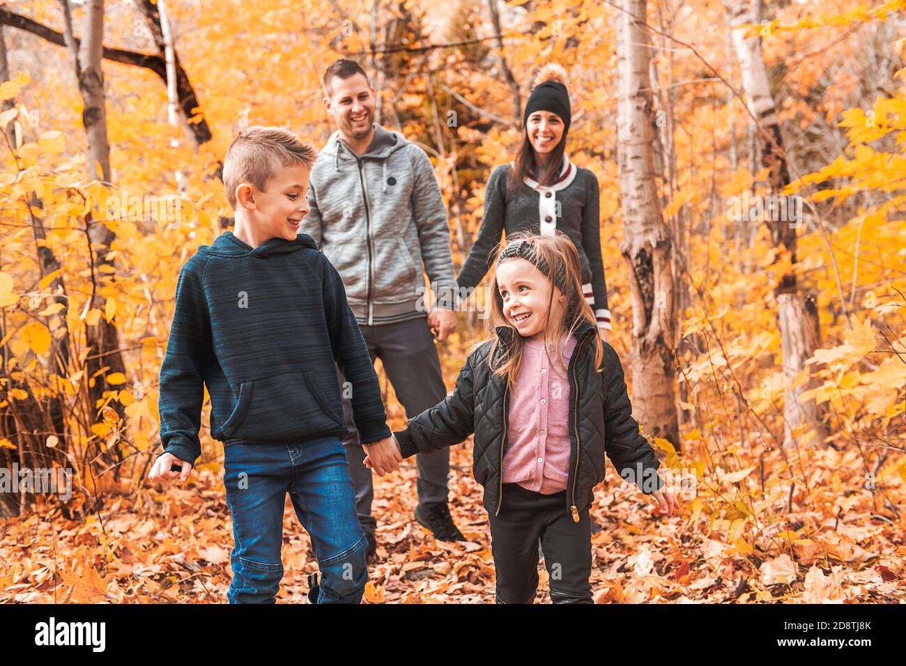 A portrait of a young family in the autumn park Stock Photo - Alamy