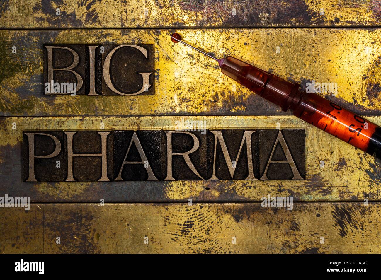 Big Pharma text message with drop of red fluid on tip of syringe on