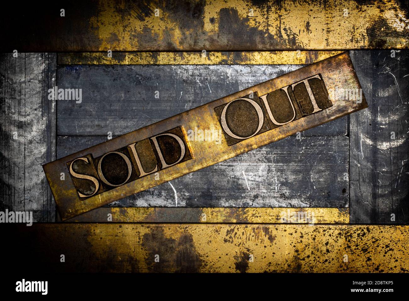 Sold Out text message on textured grunge copper and vintage gold background Stock Photo