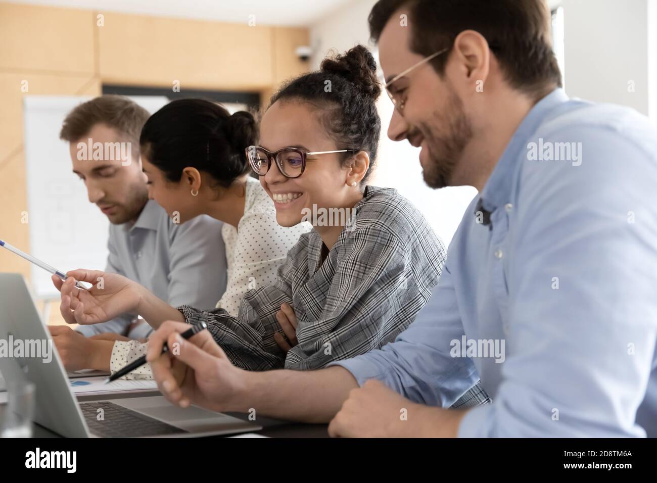 Happy smiling multiracial colleagues working on computers in office. Stock Photo