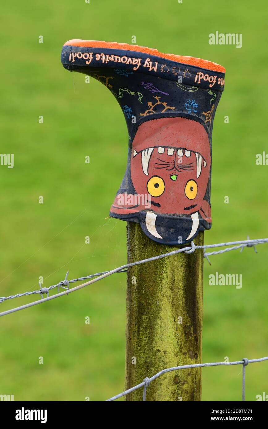 A misplaced, Children's Gruffalo-themed wellington boot is left on a fence post in the hope that its owner will return for a treasured possession! Stock Photo