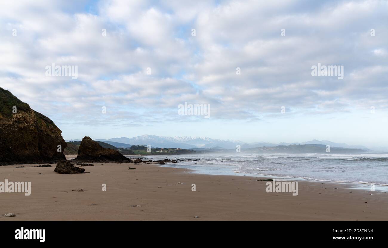 A view of wild and rocky and sandy beach at low tide Stock Photo