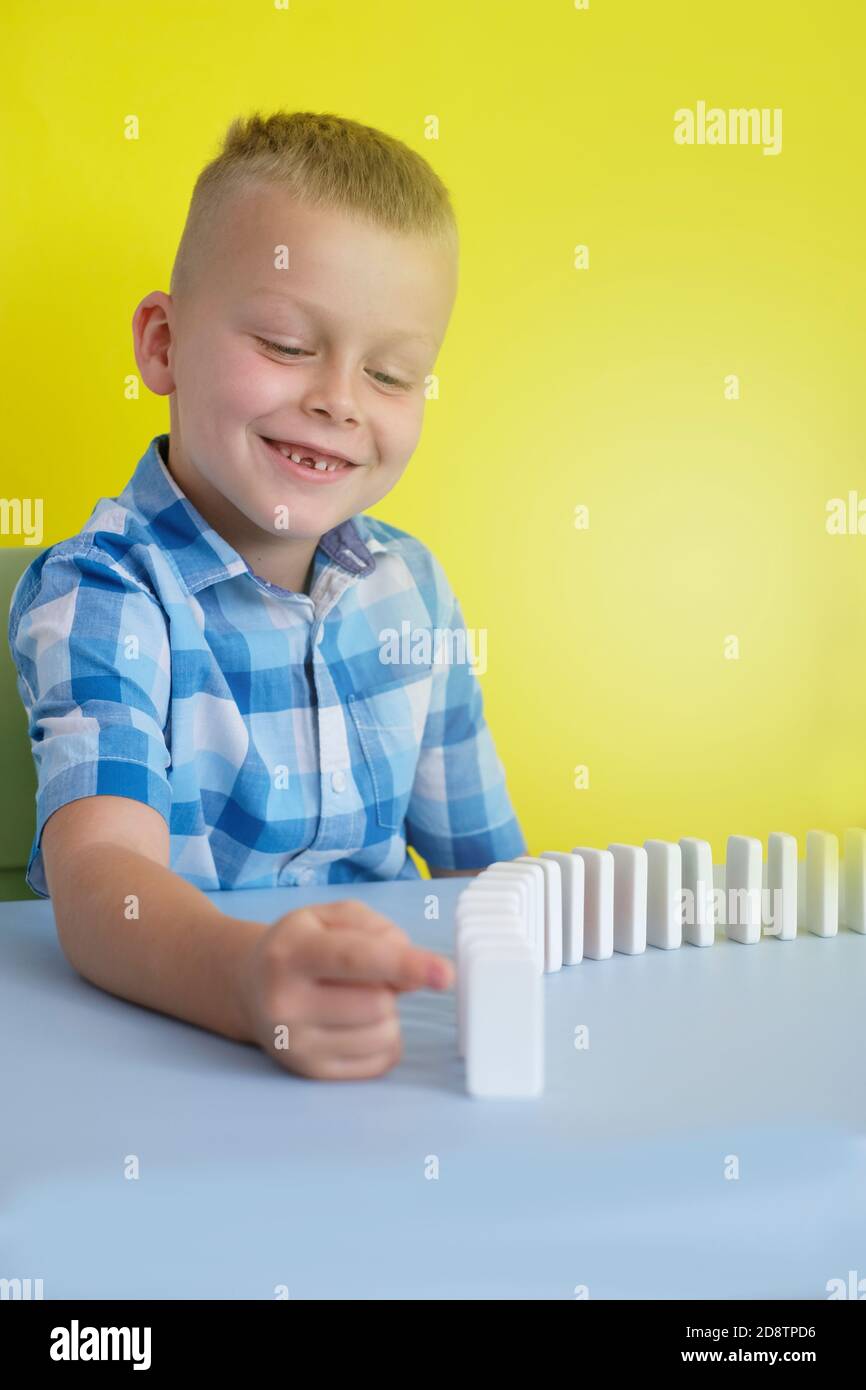 child playing board games sitting at the table Stock Photo Alamy