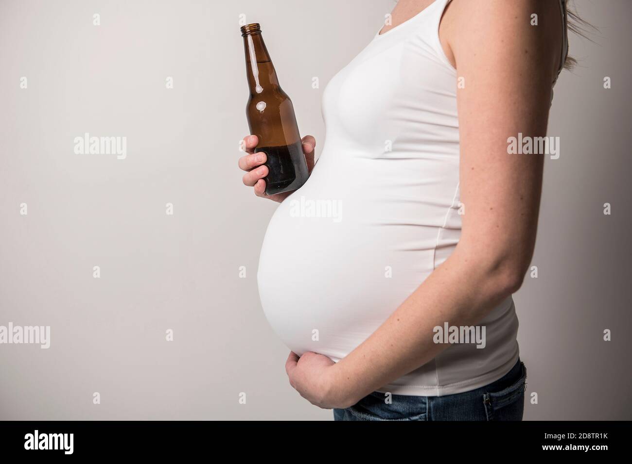 Pregnant women drinking beer on studio white Stock Photo Alamy