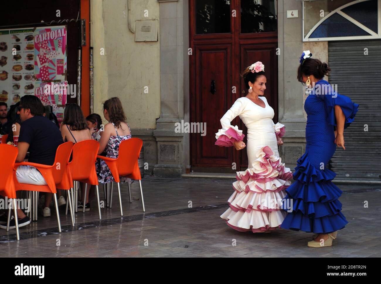 Men and women dance flamenco in the street during a break in a flamenco festival, in Seville, Spain August 16, 2019. Photograph John Voos Stock Photo