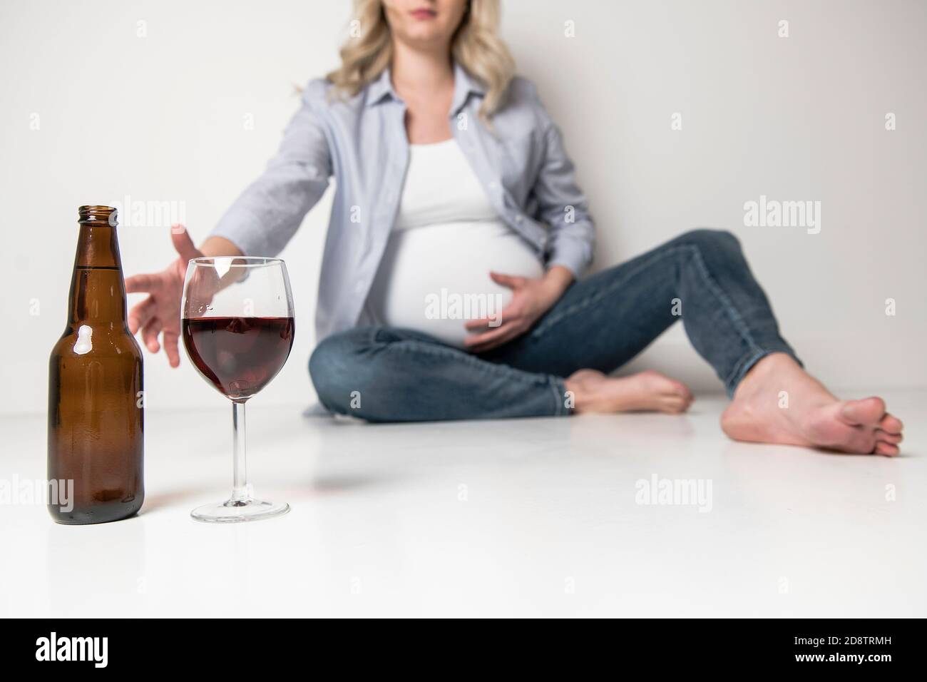 Pregnant women drinking beer on studio white Stock Photo Alamy