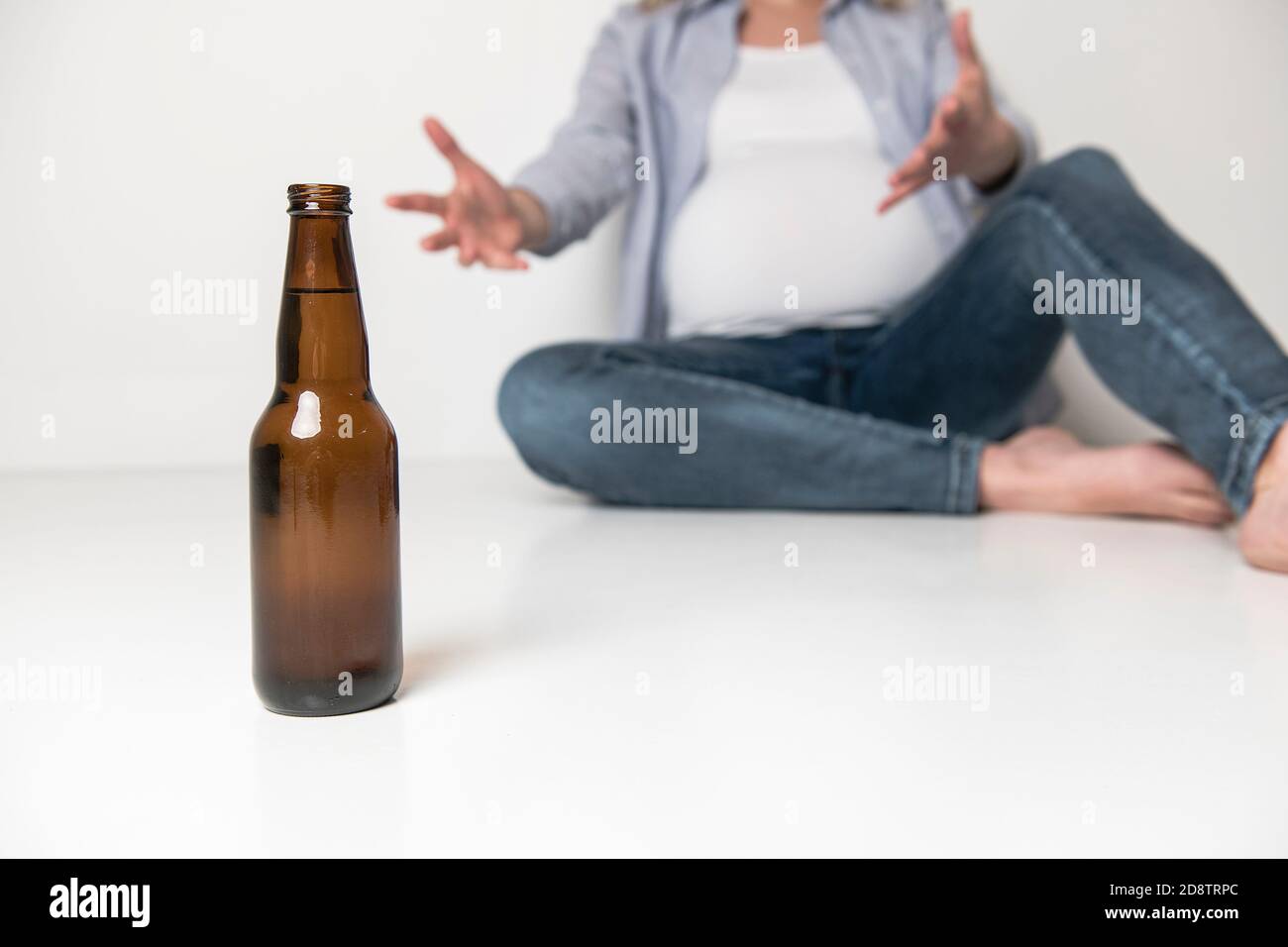 Pregnant women drinking beer on studio white Stock Photo Alamy