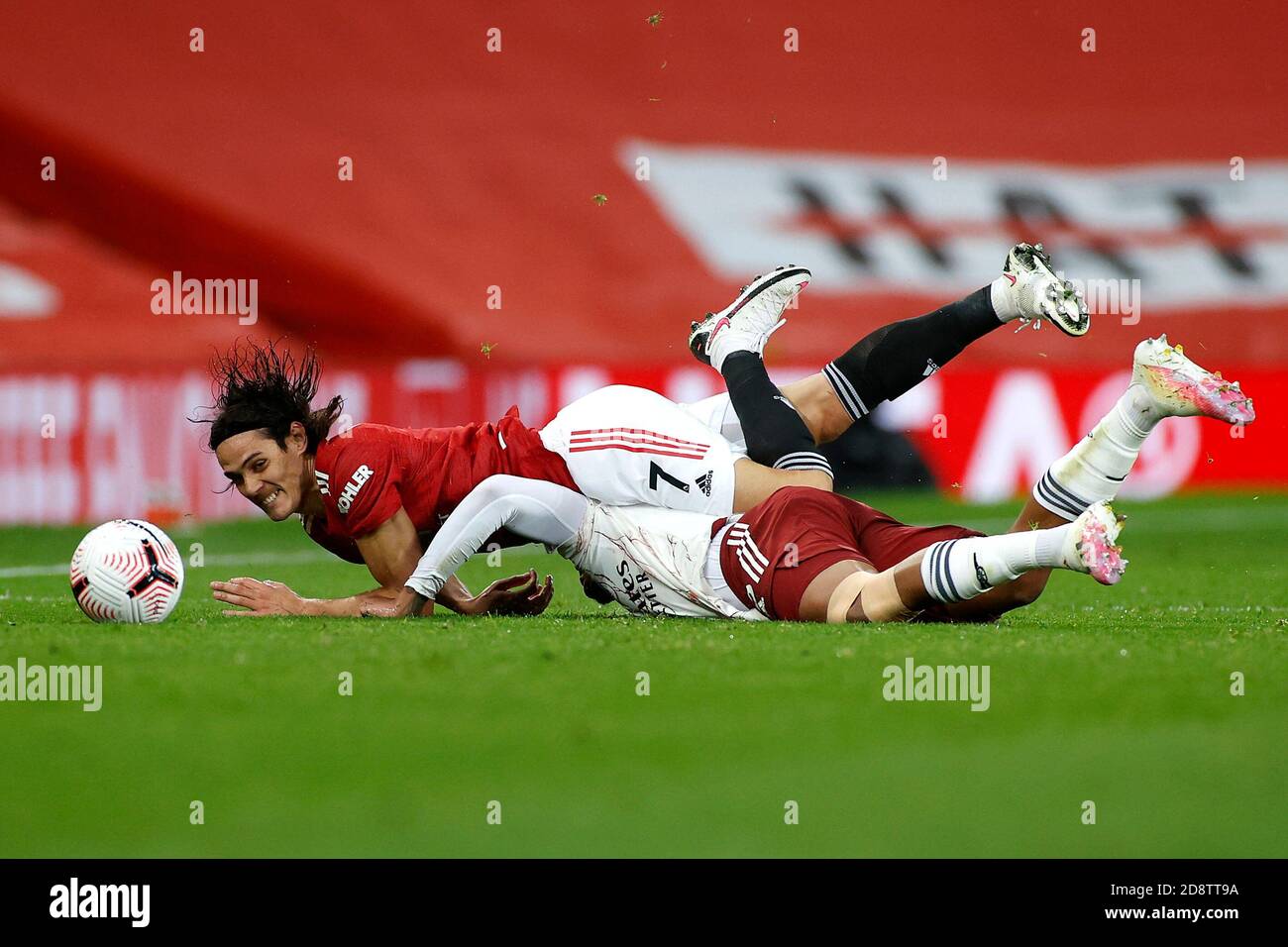 Manchester Uniteds Edinson Cavani fouls Arsenals Gabriel Magalhaes which results in a yellow card during the Premier League match at Old Trafford, Manchester Stock Photo