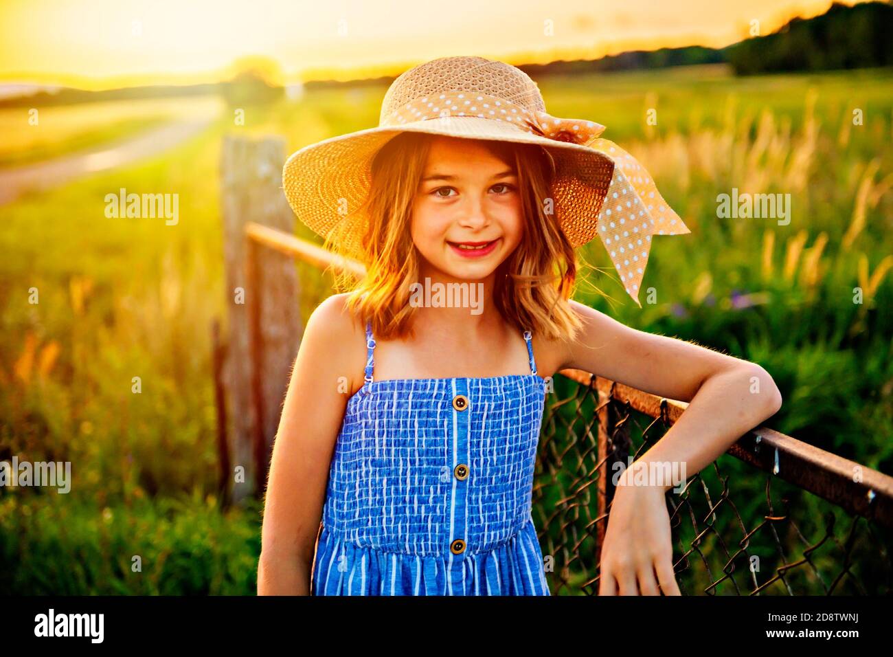 Child girl on a hay field at the sunset Stock Photo - Alamy