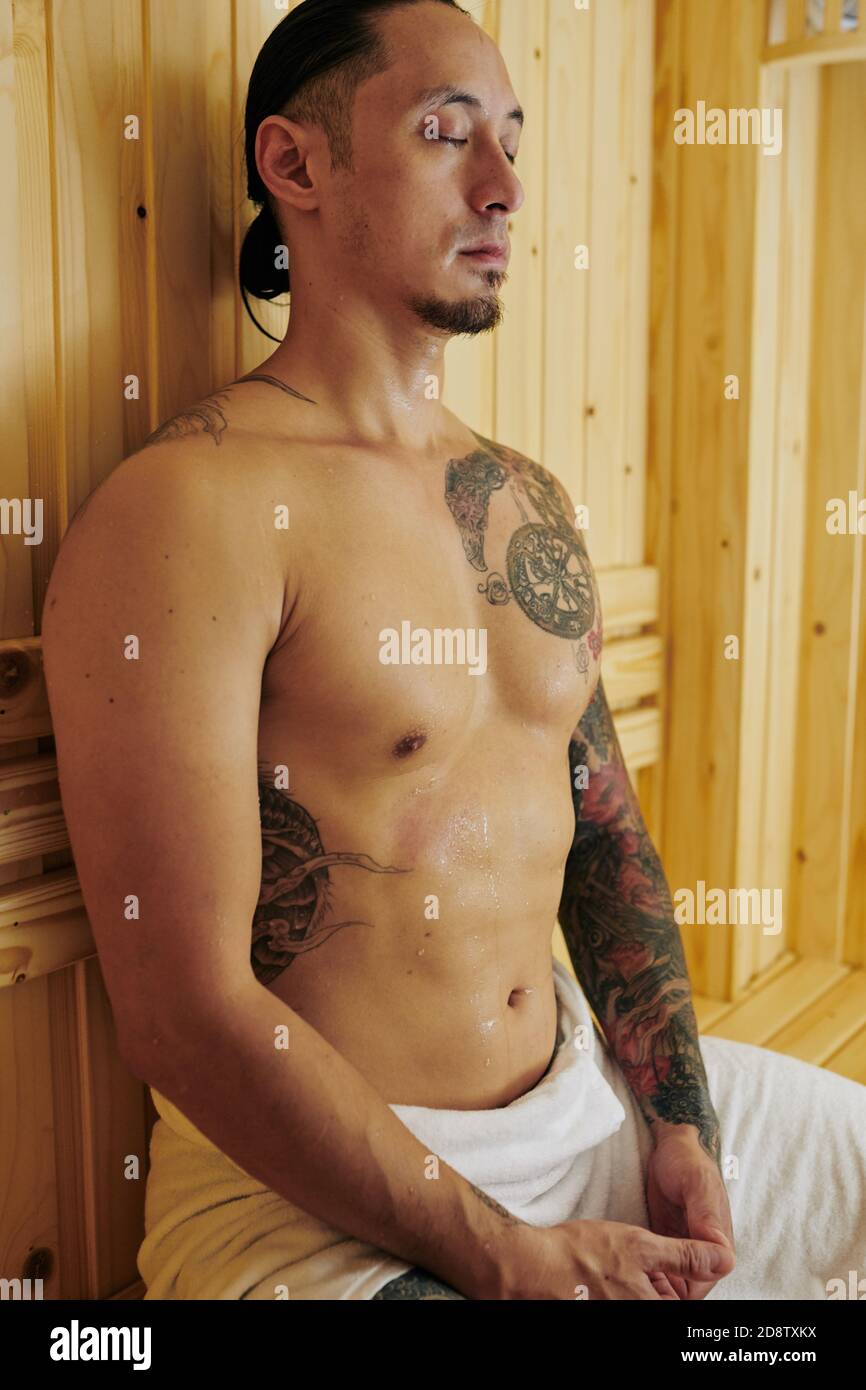 Man sweating in hot sauna Stock Photo - Alamy