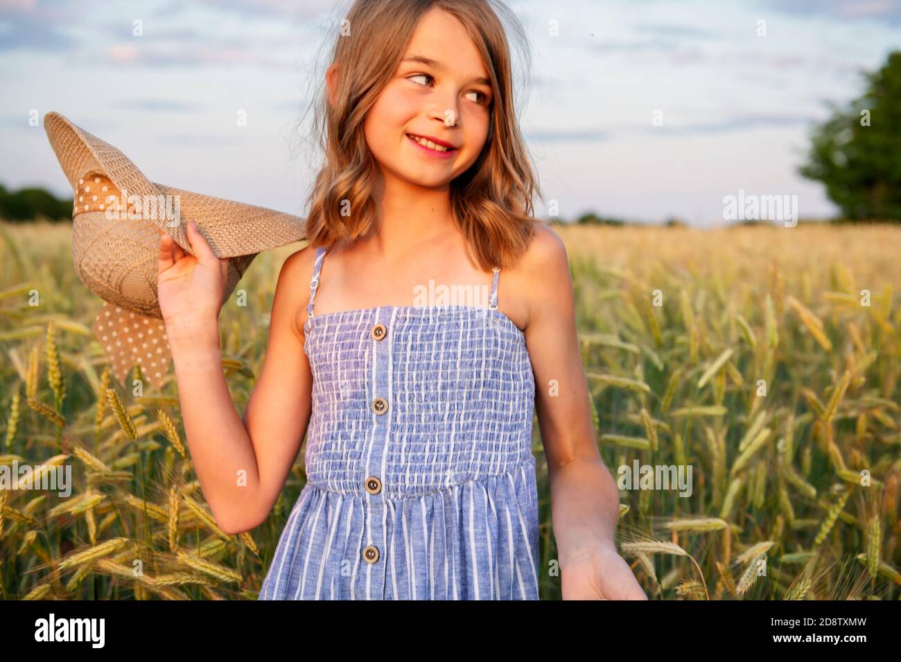 Child girl on a hay field at the sunset Stock Photo - Alamy