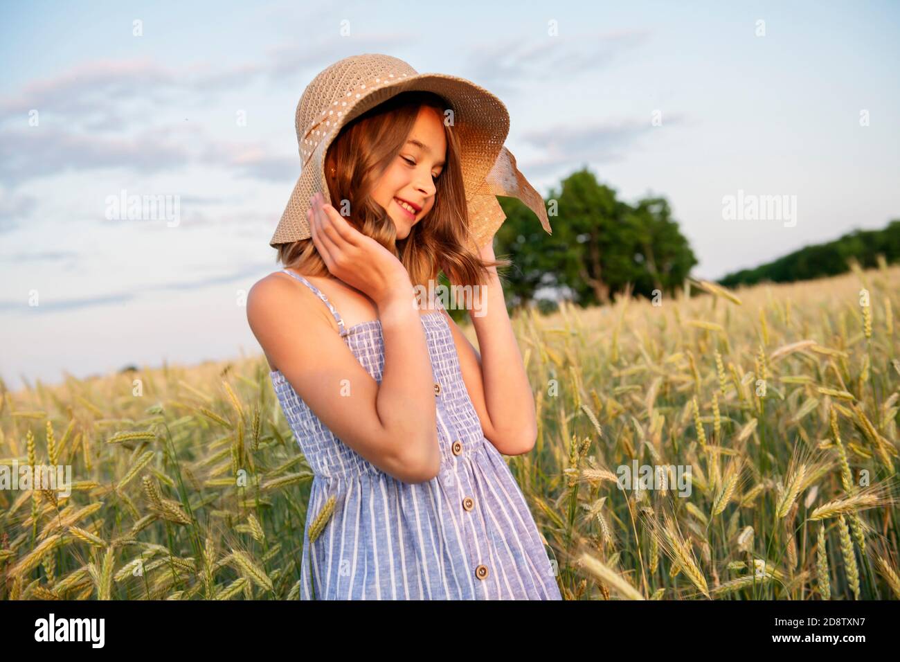 Child girl on a hay field at the sunset Stock Photo - Alamy