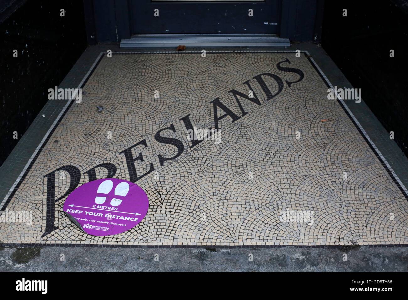 A Covid-19 sign in a shop doorway, Darlington, County Durham, UK. 30/10/2020. Photograph: Stuart Boulton Stock Photo