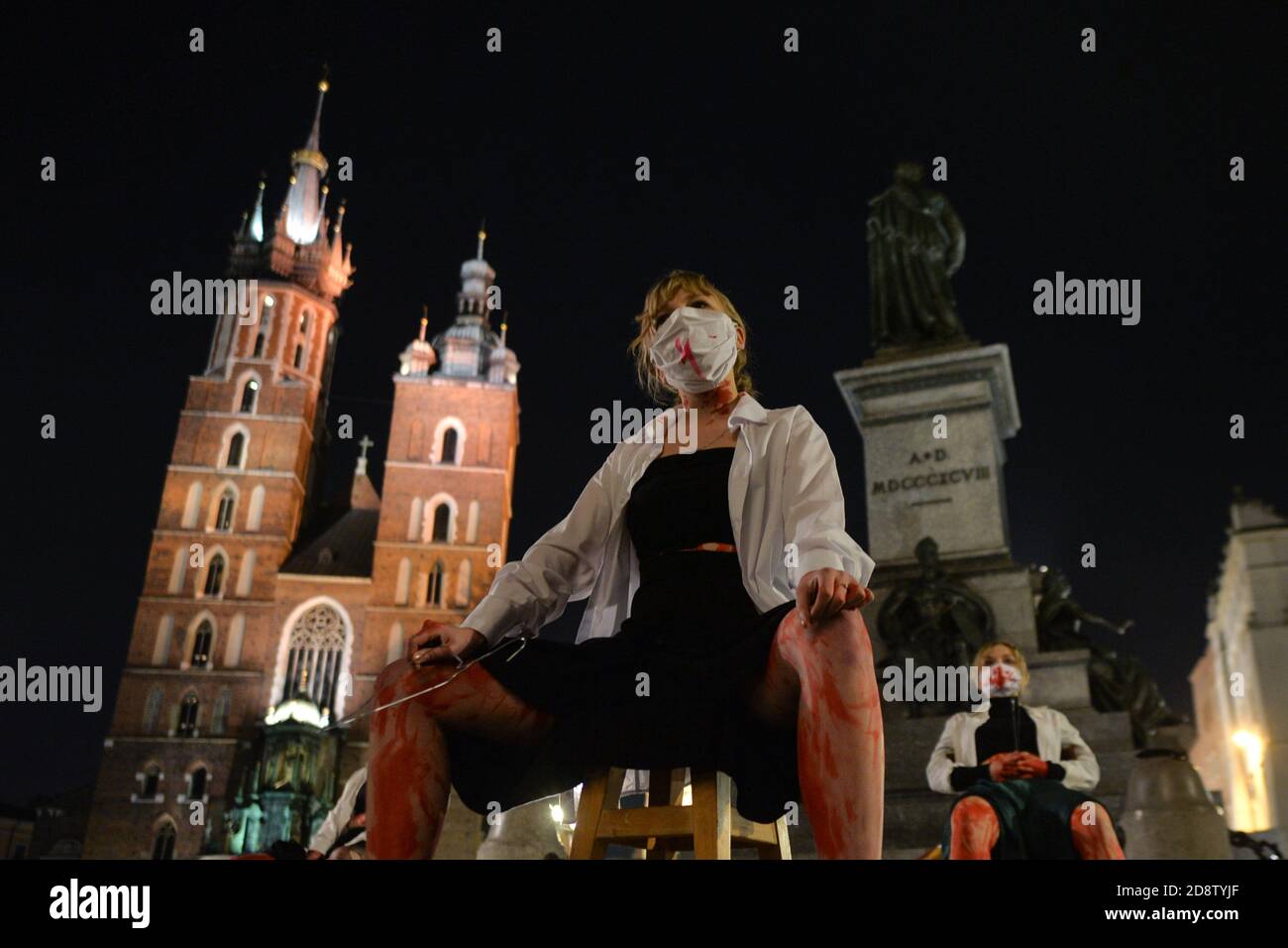 Krakow, Poland. 1 November, 2020. Pro-Choice activists during a protest next to Adam Mickiewicz monument in Krakow's Main Market Square. Pro-Choice and women's rights activists and their supporters organised on Sunday evening another anti-government protest in Krakow to express their anger at the Supreme Court ruling in relation to abortion laws.. Credit: ASWphoto/Alamy Live News Stock Photo