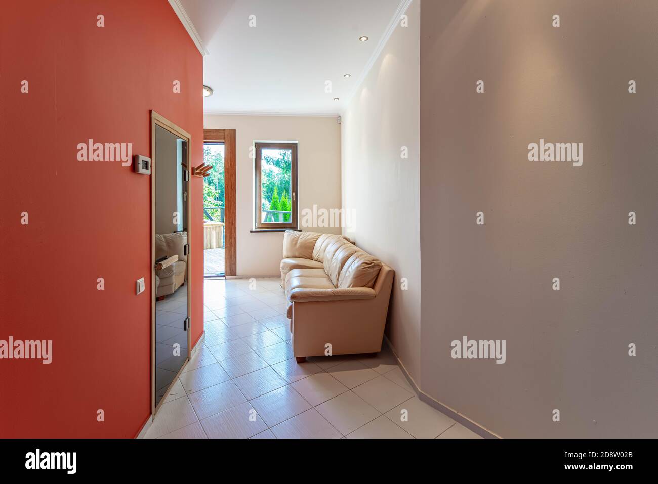 Modern interior of hall in luxury private house. Cozy leather sofa. Red ...