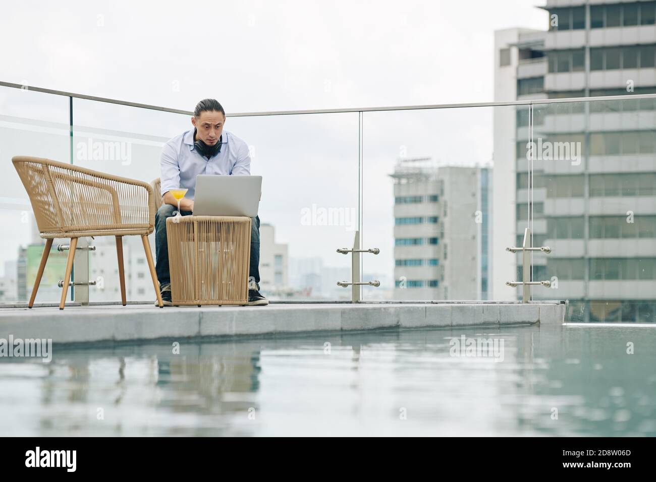 Young man working on rooftop Stock Photo