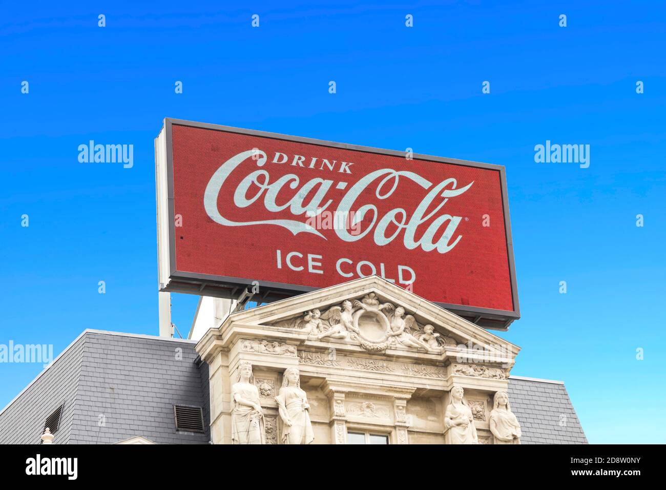 Brussels, BELGIUM - July 7, 2019: Large Coca Cola billboard on rooftop against sky, Coca-Cola advertising sign on rooftop. Stock Photo