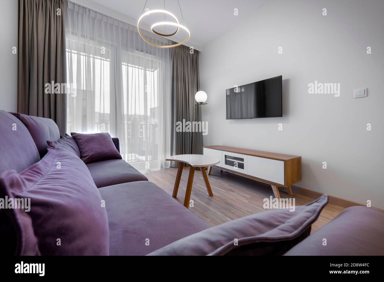 Modern Scandinavian Living Room Interior Design With Wooden Floor And Purple Sofa Stock Photo Alamy