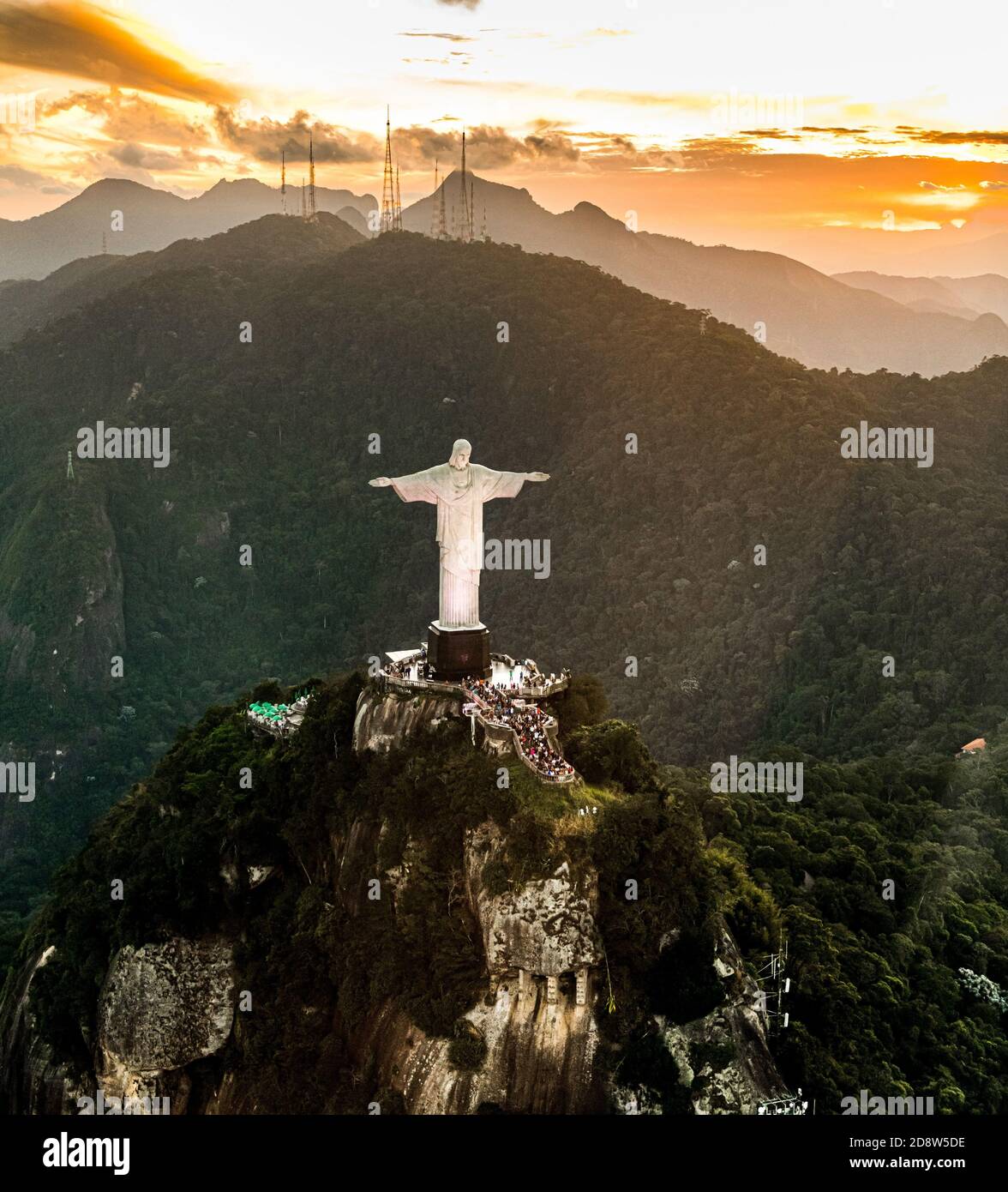 Cristo Redentor statue in Rio de Janeiro (aerial shot made from a helicopter) during a spectacular sunset Stock Photo