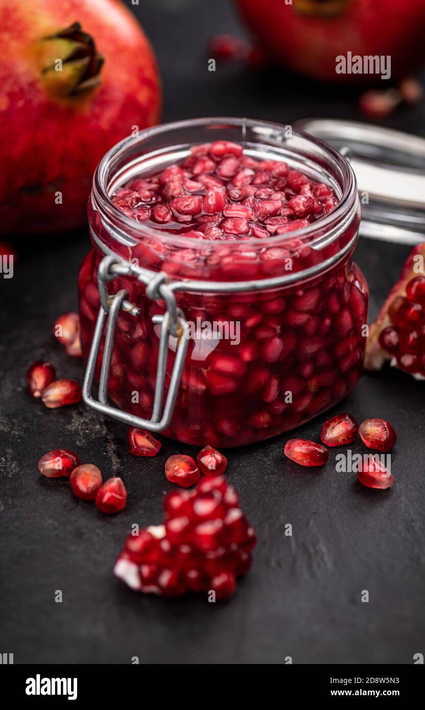 Portion of healthy preserved Pomegranate seeds on a slate slab (selective focus) Stock Photo