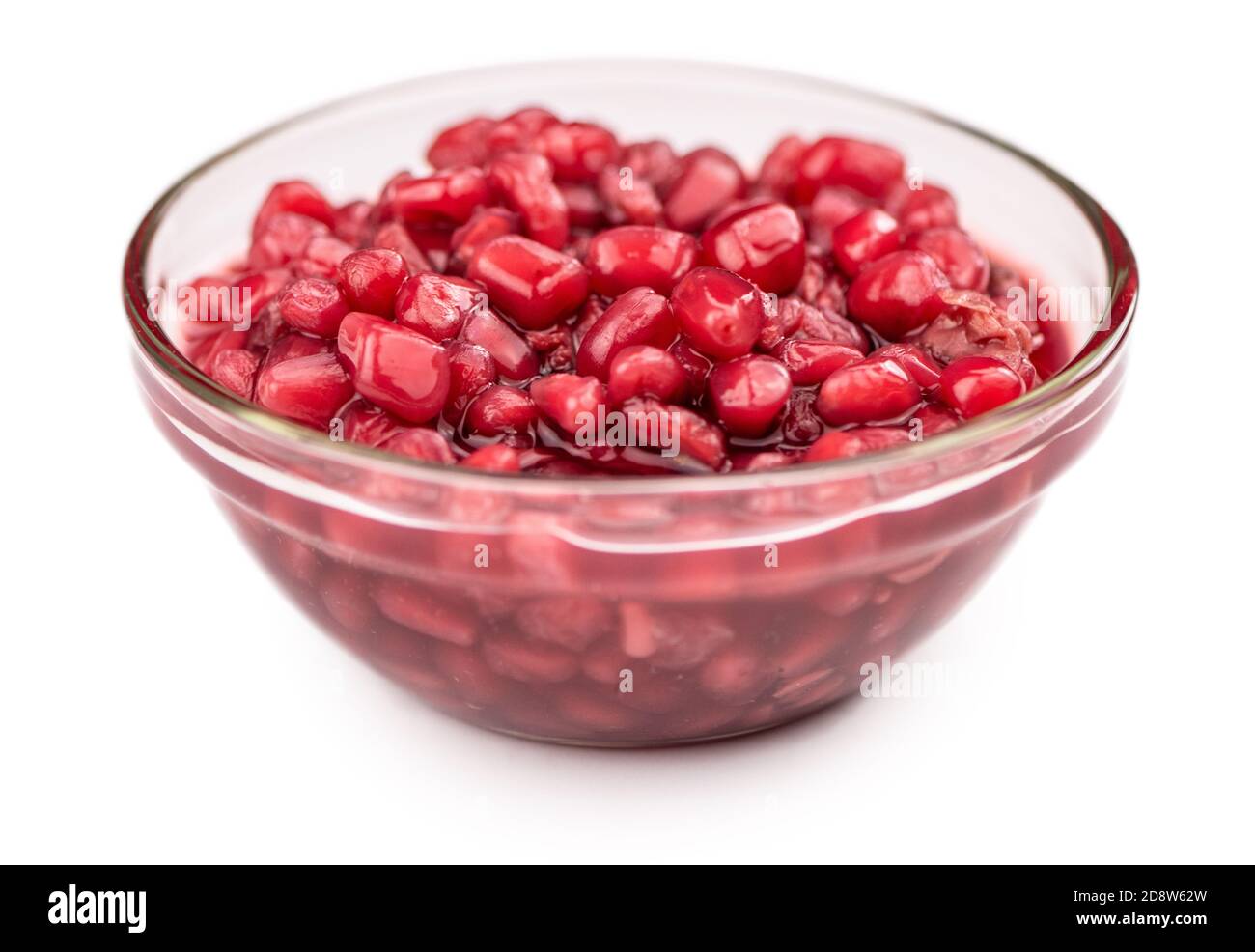 Some preserved Pomegranate seeds isolated on white (selective focus) Stock Photo