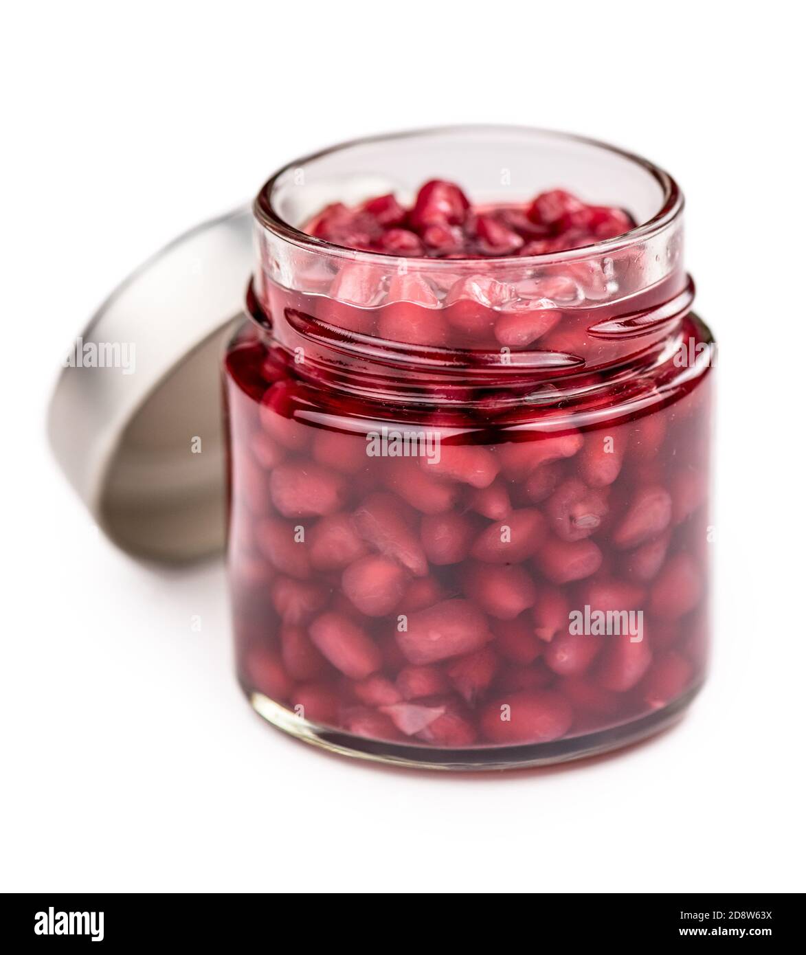 Some preserved Pomegranate seeds isolated on white (selective focus) Stock Photo