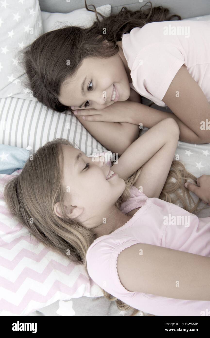 Sharing secrets. Kids relaxing on bed. Sisters preparing sleep. Nice  evening. Best friends. Children friends. Charming cute kids have free time  before sleep. Dialogue best friends. Sisterhood concept Stock Photo - Alamy