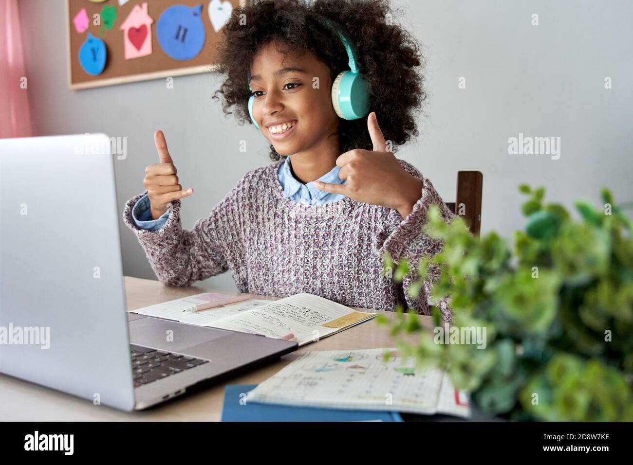 African mute kid girl showing sign language gesture learning online. Stock Photo
