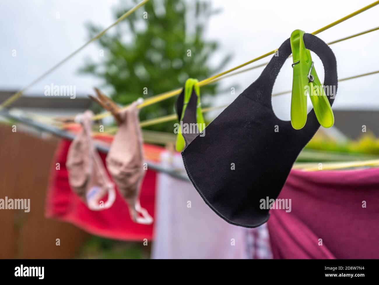 Face mask drying on clothes line Stock Photo