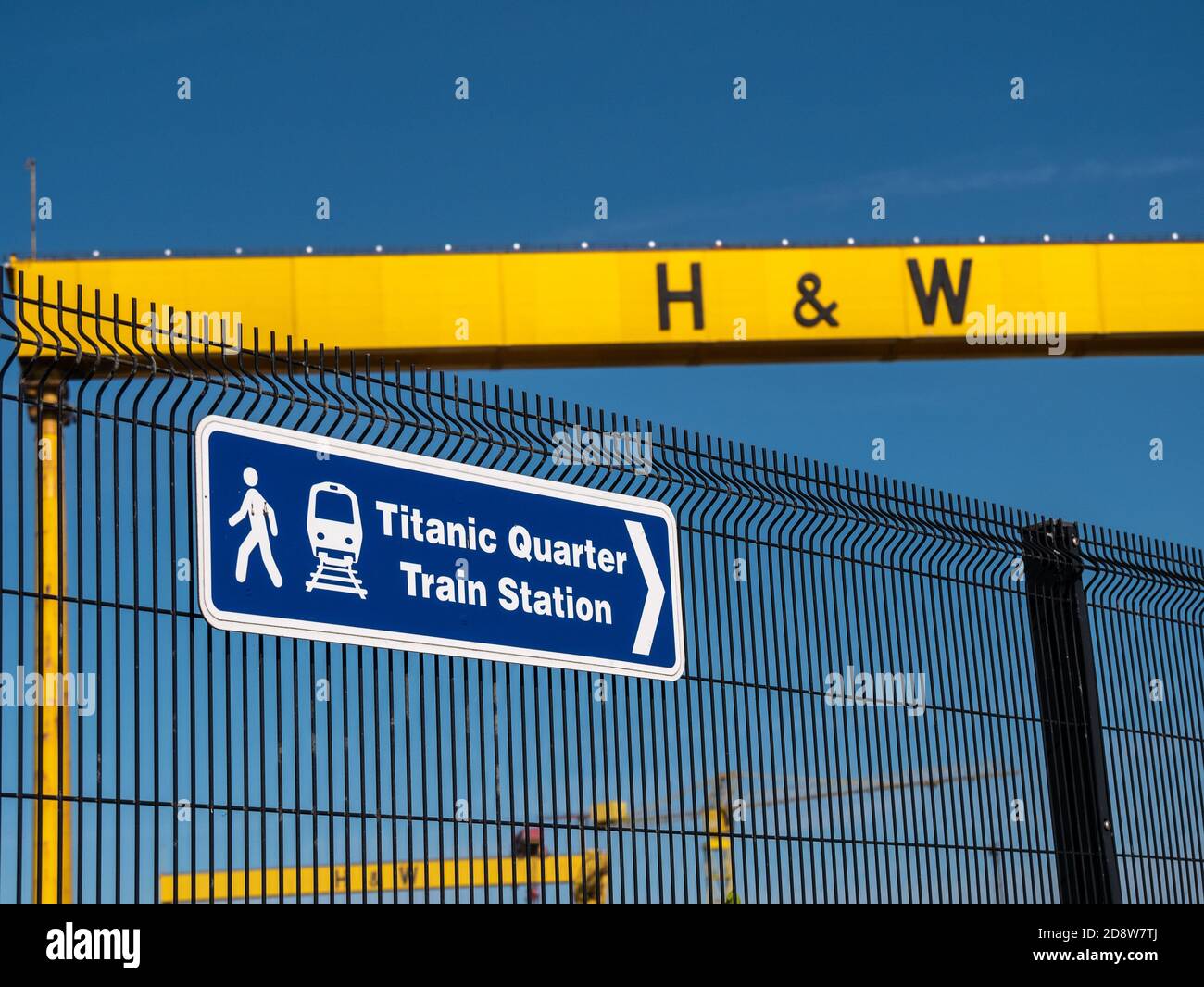 Titanic Quarter Train Station sign with Shipyard crane in the background, Queens Road, Belfast, Northern Ireland Stock Photo