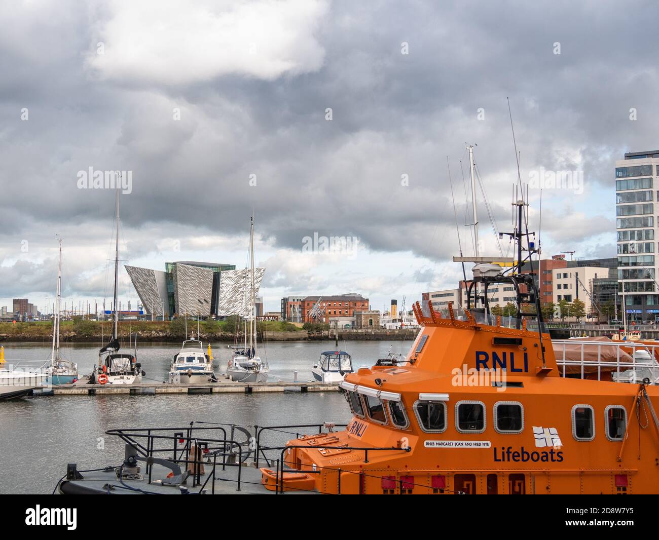 RNLI Lifeboat in Belfast Harbour Marina with Titanic Belfast in background Stock Photo