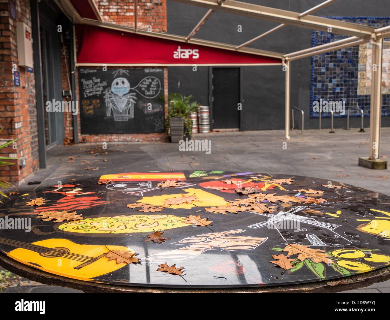 An outside table with Autumn leaves during lock down at 2Taps wine bar