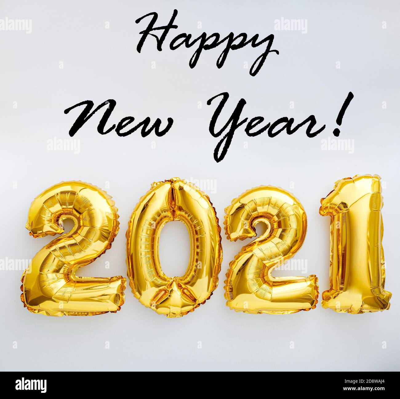 Happy New year text with gold foil balloons 2021 on white background. New Year eve invitation 2021. Square flat lay Stock Photo