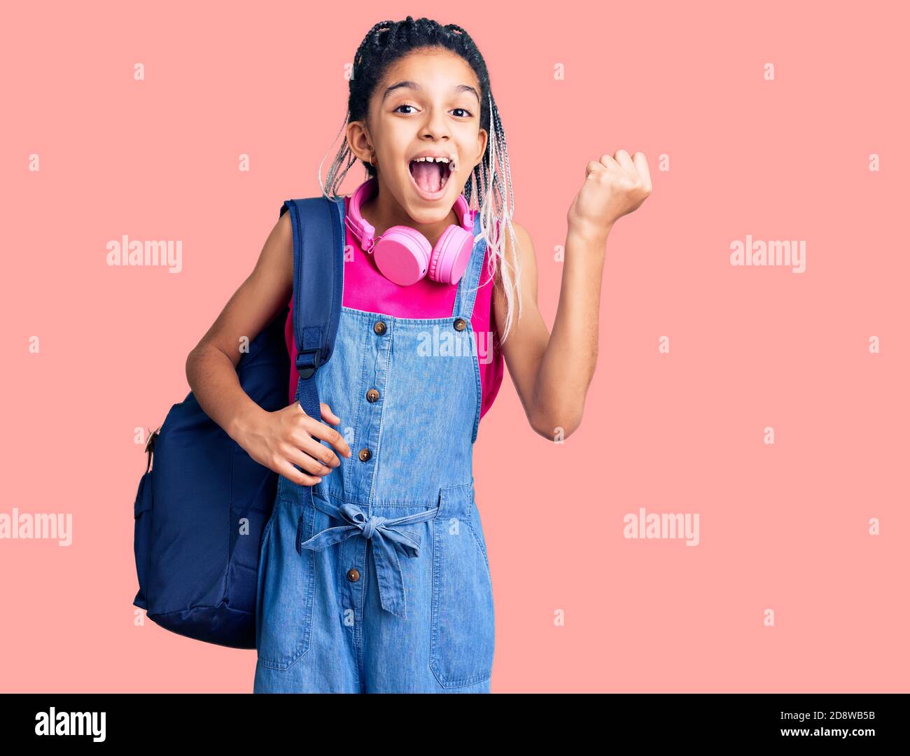 Cute african american girl holding student backpack using backpack ...