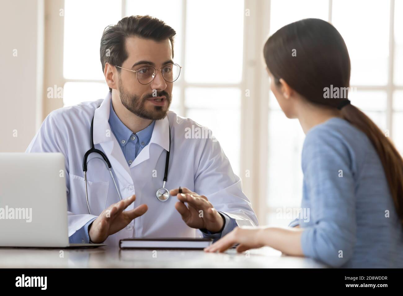 Concentrated attentive therapist professional consulting client in office Stock Photo