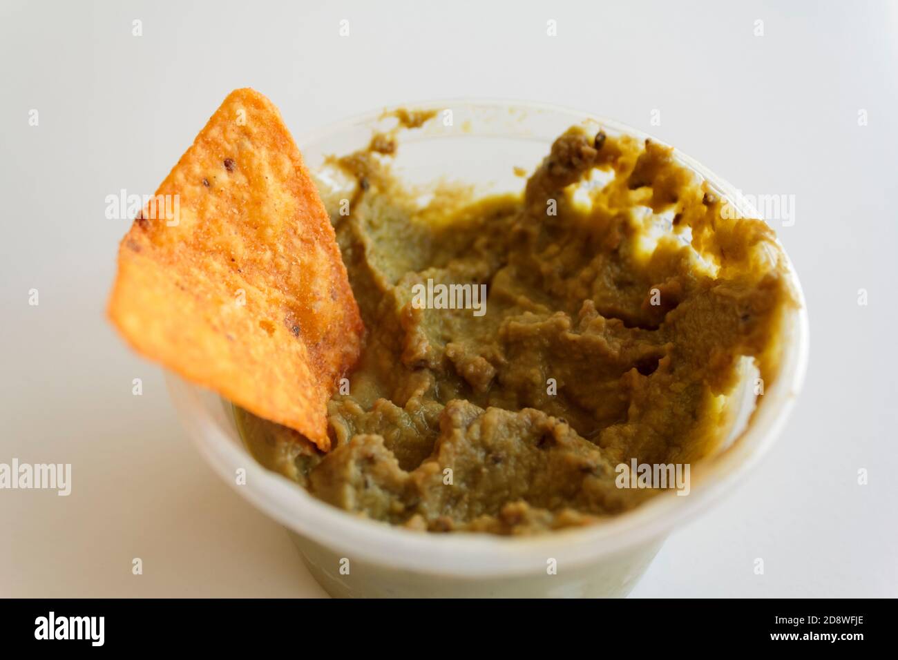 Guacamole with nachos on white background Stock Photo
