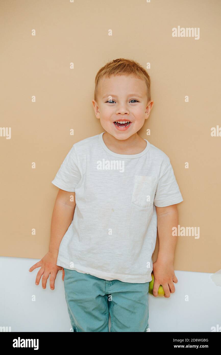 Portrait of a cheerful 5 year old boy over brown background Stock Photo Alamy