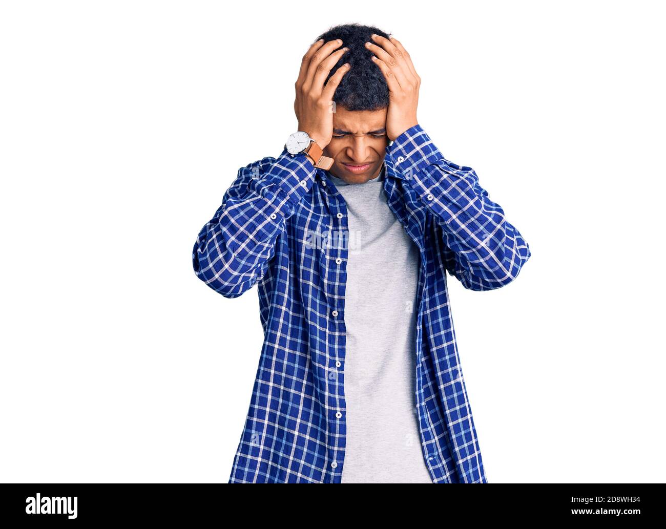 Young african amercian man wearing casual clothes suffering from headache desperate and stressed because pain and migraine. hands on head. Stock Photo