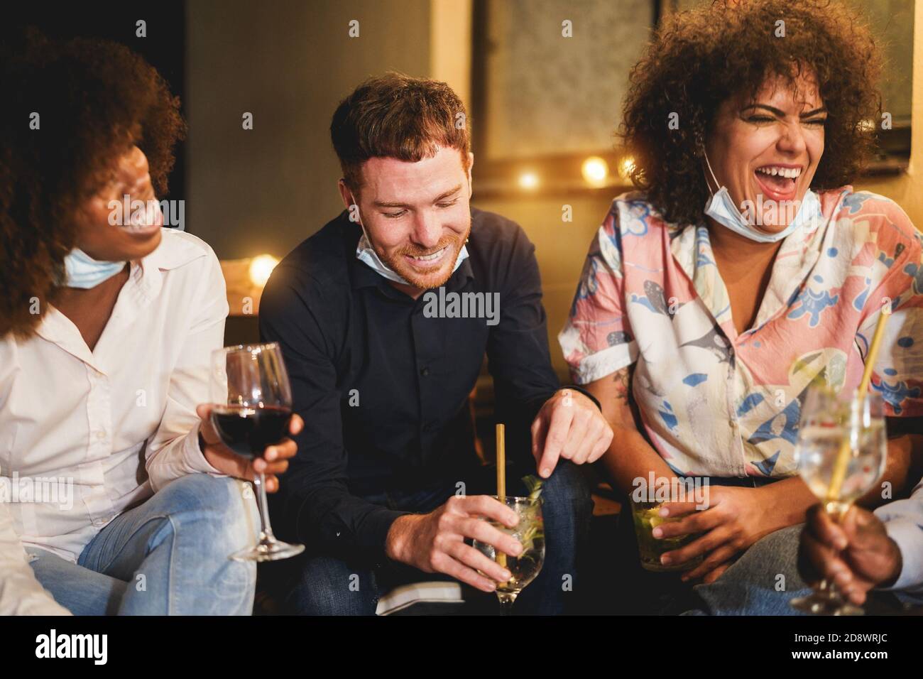 Social Distance Drinking Happy multiracial firends drinking cocktails at terrace party wearing ...