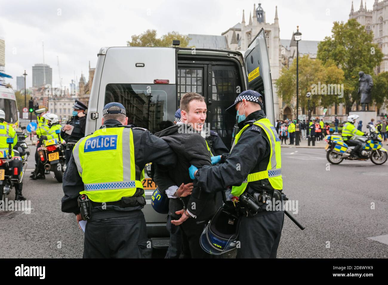 London, UK. 24 October 2020. Police officers arrest man during COVID-19 lockdown protest in Parliament Square. Credit: Waldemar Sikora Stock Photo