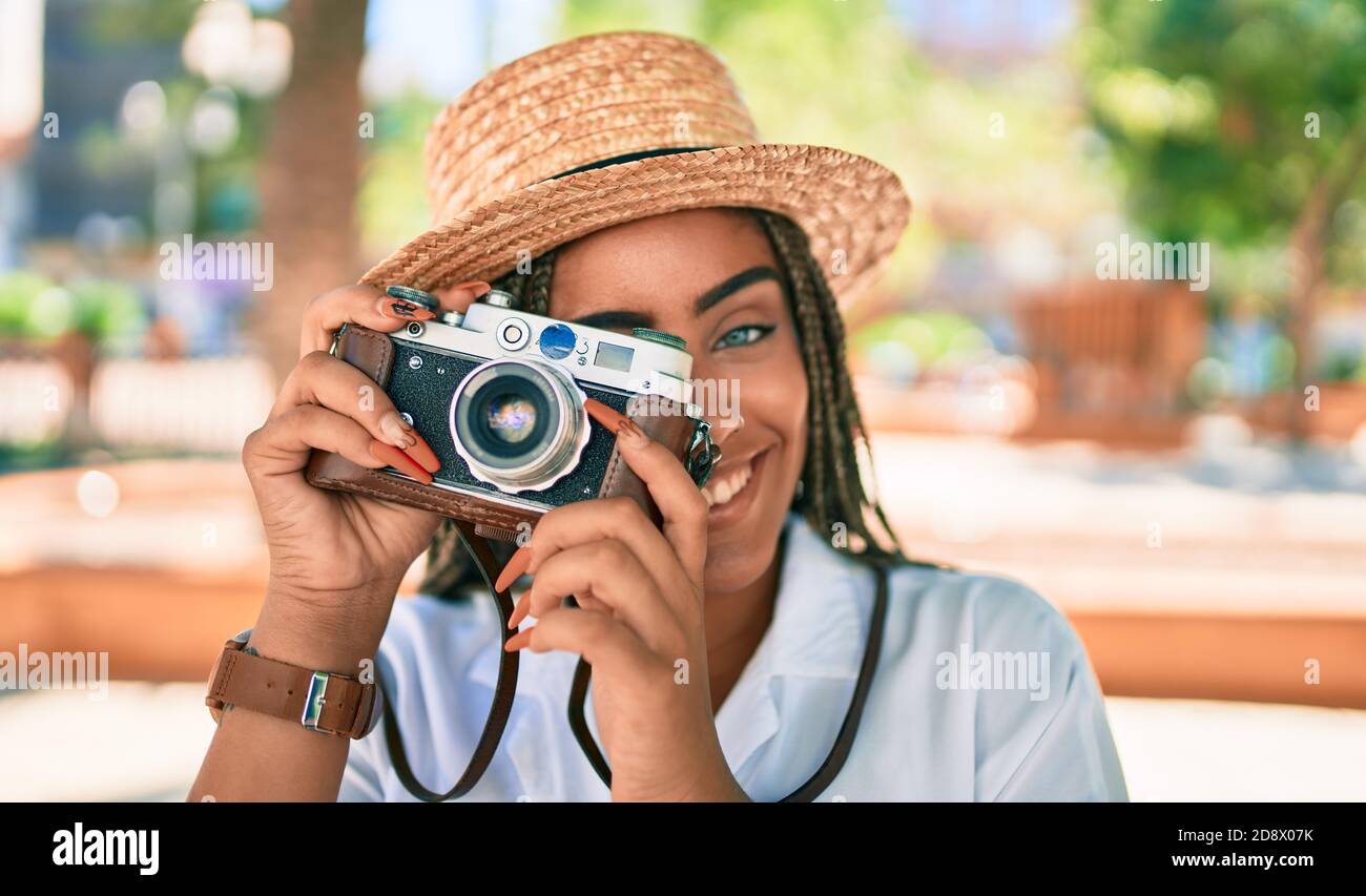 Young african american woman with braids smiling happy taking pictures ...