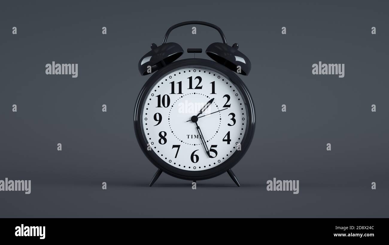 Close-up of an analog alarm clock on dark background. (Black) Stock Photo