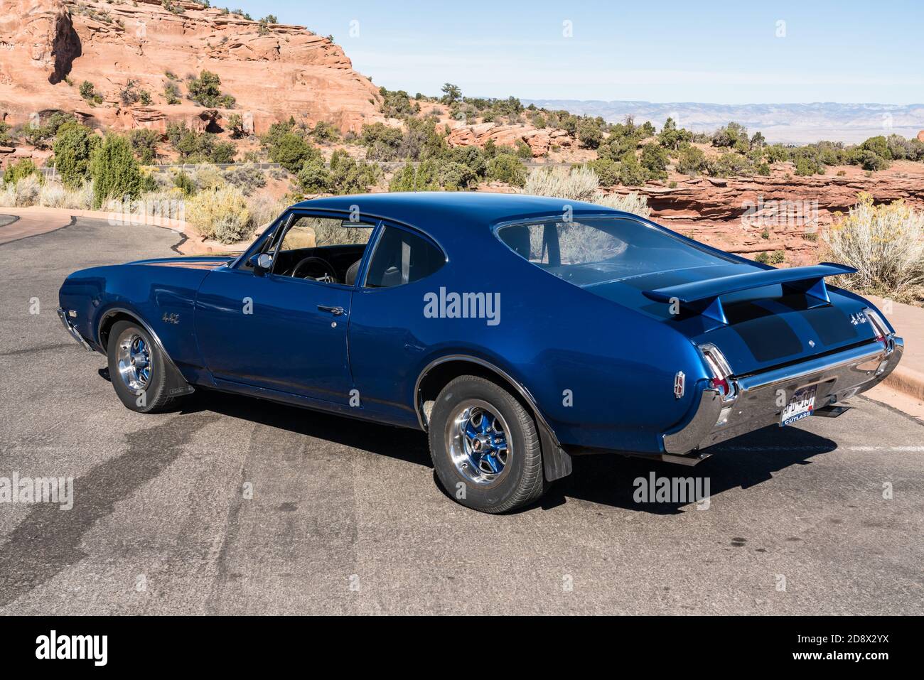 A restored vintage 1969 Oldsmobile 442 muscle car parked at a
