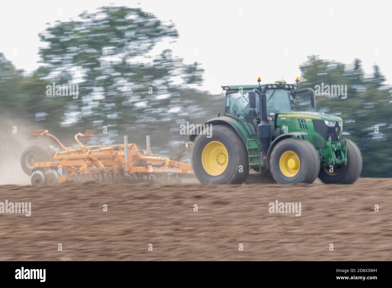 John Deere 625R tractor cultivating field Stock Photo
