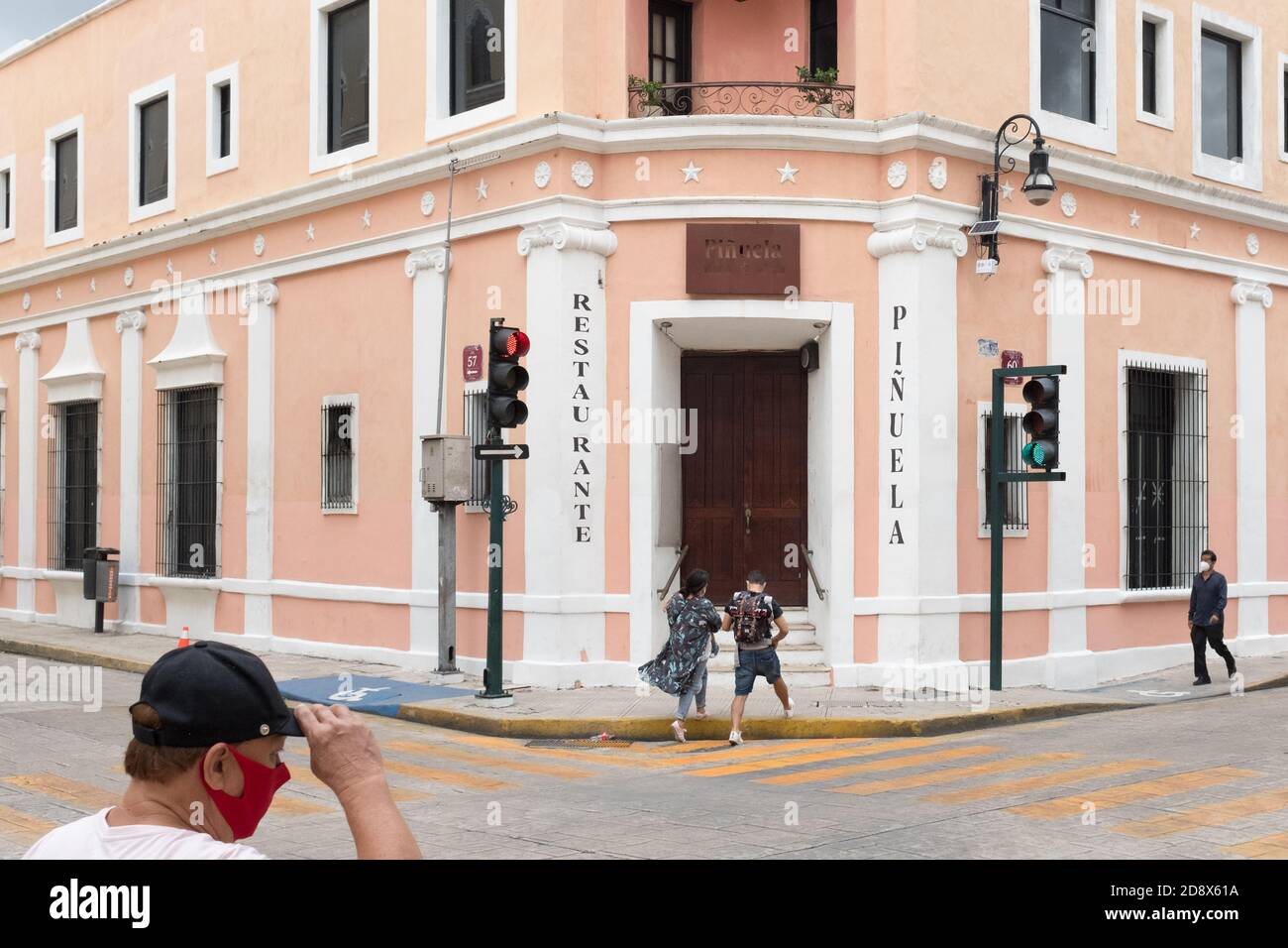 People walking in a mostly empty downtown Merida during the Covid19 Pandemic, November 2020 - Many shops being closed and many businesses went out of business because of the Coronavirus restrictions. Merida, Yucatan, Mexico Stock Photo