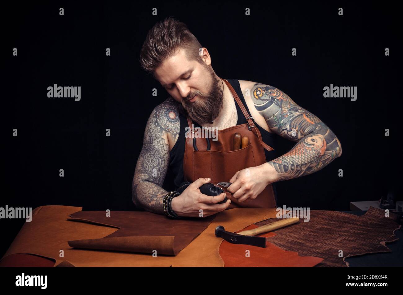 Tanner of leather produces leather goods at the studio Stock Photo