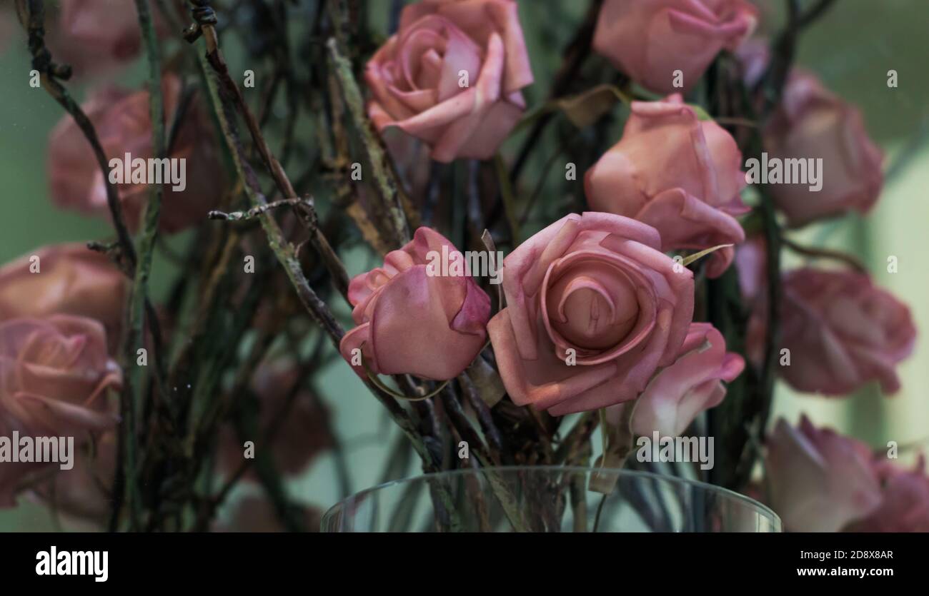 Cloth roses in glass vase, selective focus Stock Photo