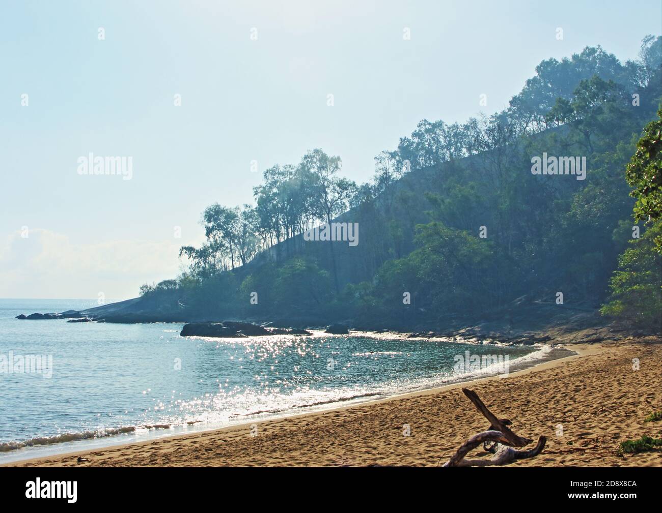 Smoke still visible in the morning on the headland as the overnight fire at the Earl Hill end of Trinity Beach still smolders Stock Photo