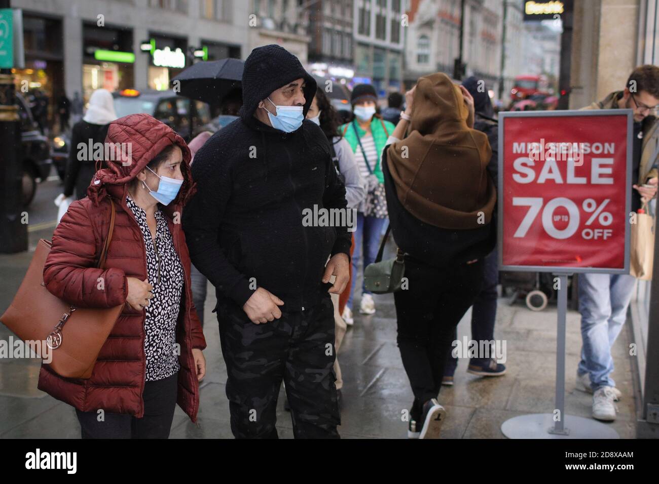 London, Britain. 1st Nov, 2020. Shoppers look in a store window on Oxford Street in London, Britain, on Nov. 1, 2020. British Cabinet Office Minister Michael Gove on Sunday admitted the month-long lockdown, which will be imposed in England on Thursday, could be extended if rates of infection do not fall sufficiently. Gove made the statement after British Prime Minister Boris Johnson announced the new restrictions, which are set to last until Dec. 2, at a press conference from Downing Street on Saturday. Credit: Tim Ireland/Xinhua/Alamy Live News Stock Photo