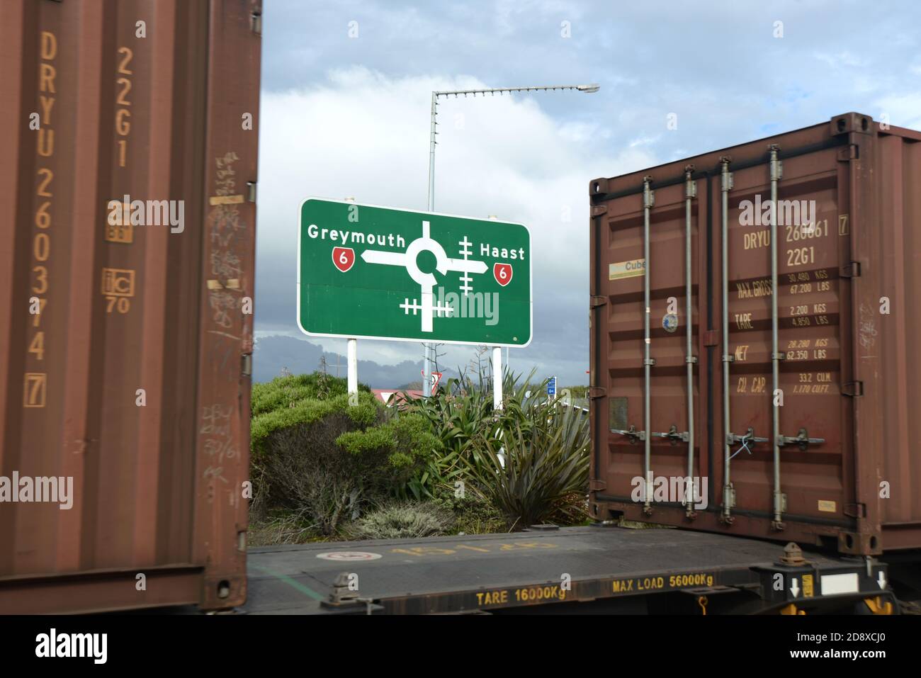 HOKITIKA, NEW ZEALAND, AUGUST 29, 2020: A freight train crosses the main street of Hokitika near the roundabout on State Highway 6. Stock Photo